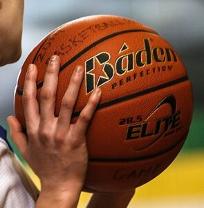 A female holding the best indoor basketball ball for college